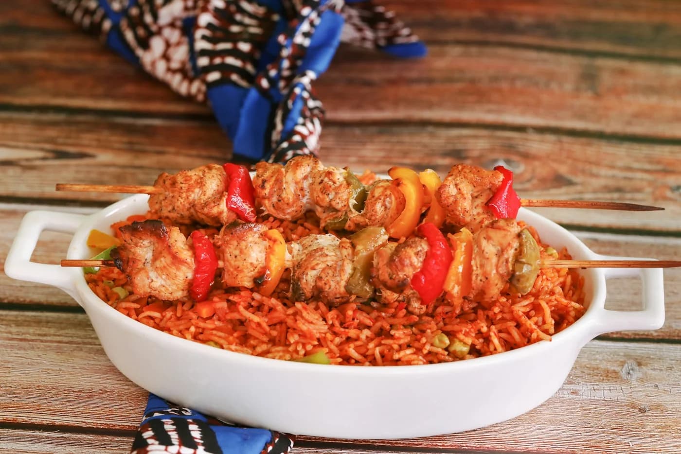 Jollof rice with grilled chicken skewers